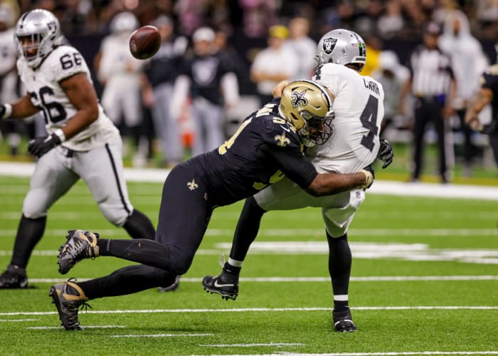 New Orleans Saints defensive end Cameron Jordan tackles Las Vegas Raiders quarterback Derek Carr as the ball flies out of the quarterback’s hands